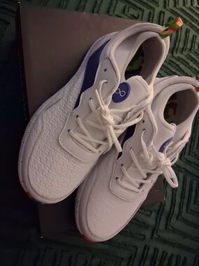 White Low-Top Sneakers with Blue Accent and Rainbow Pull Tab